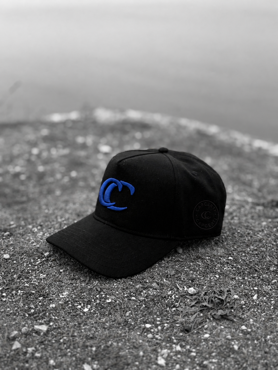 Close view of the black CC Essential Cap with blue embroidery
